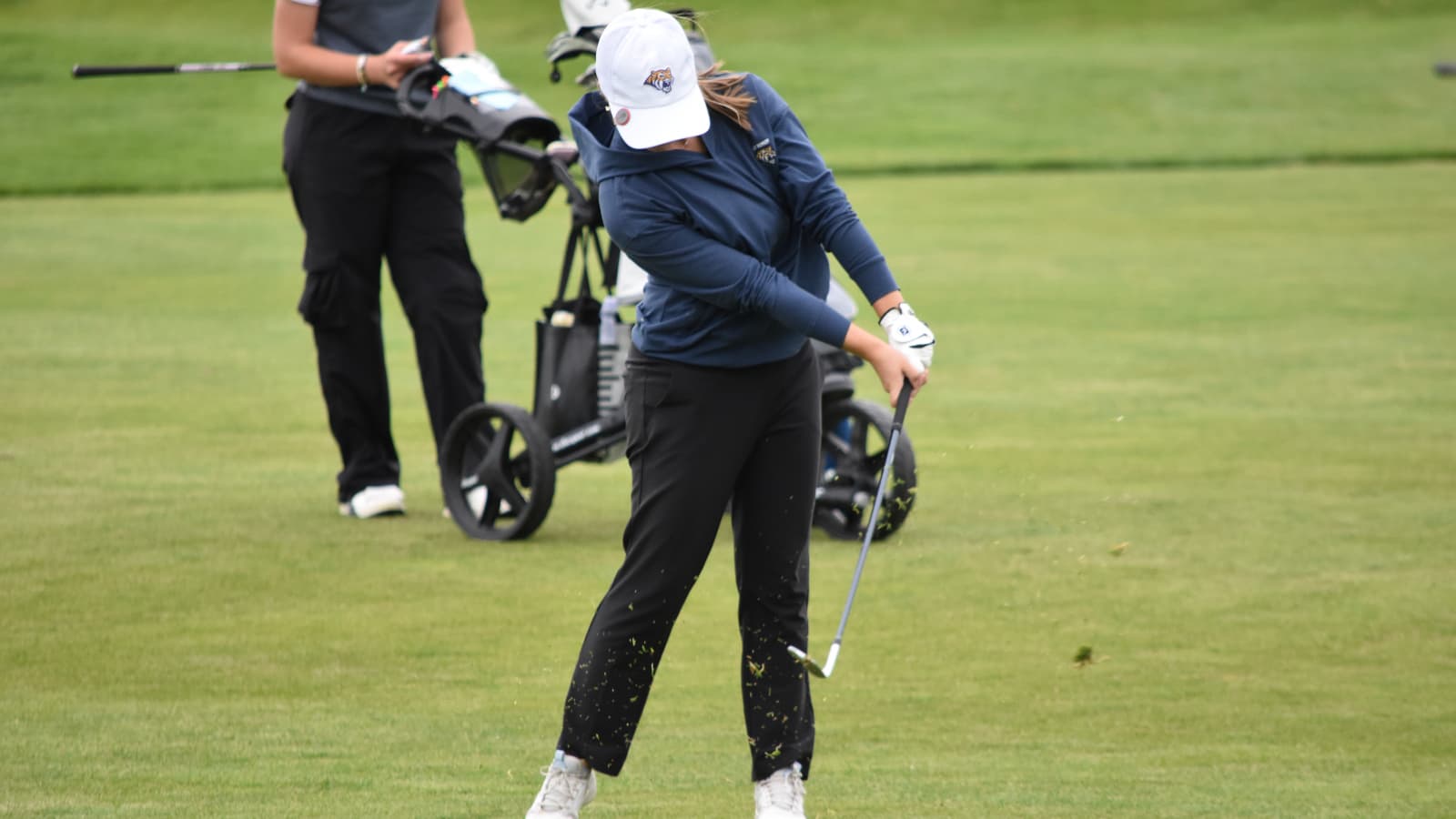 A Holy Family golfer swings