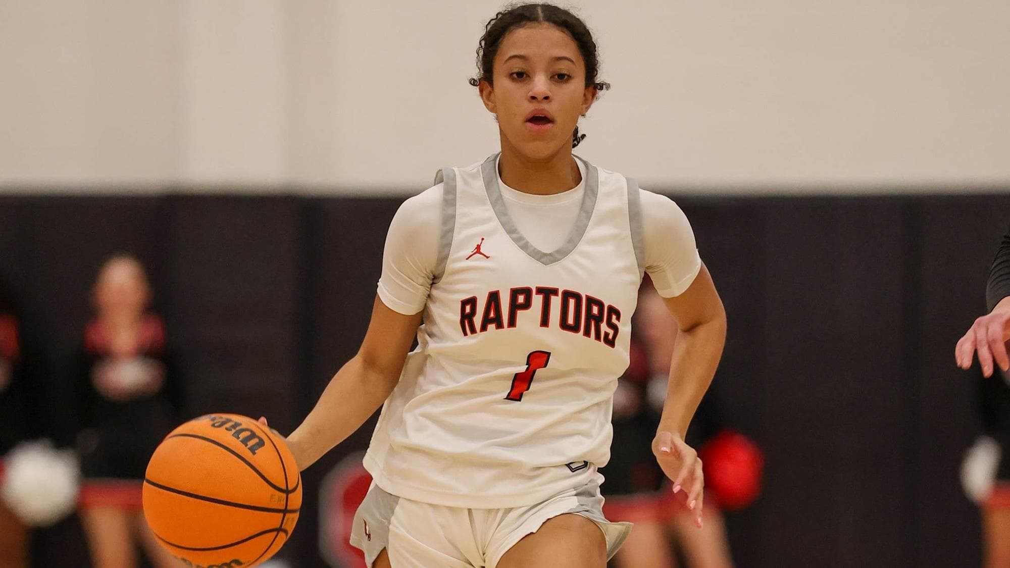 Eaglecrest's Kiarra Spellman dribbling the basketball