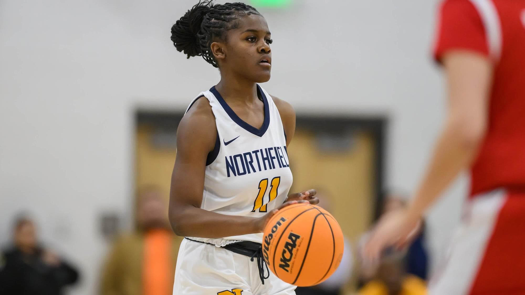 Northfield's London Taylor dribbling the basketball