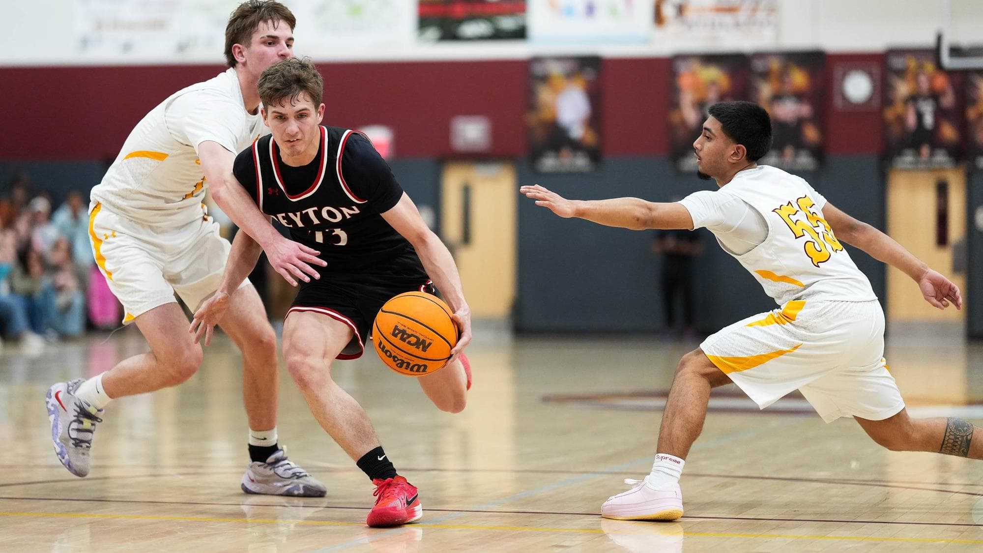 Michael Perry of Peyton drives with the basketball