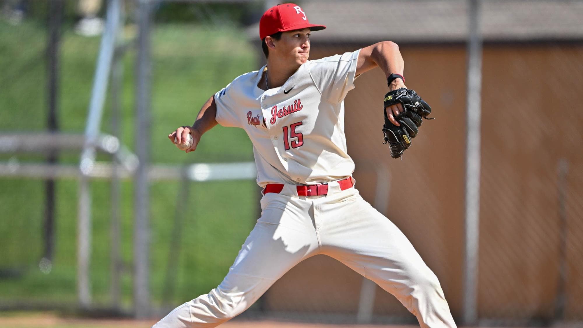 Regis Jesuit's Hudson Alpert pitching in a baseball game