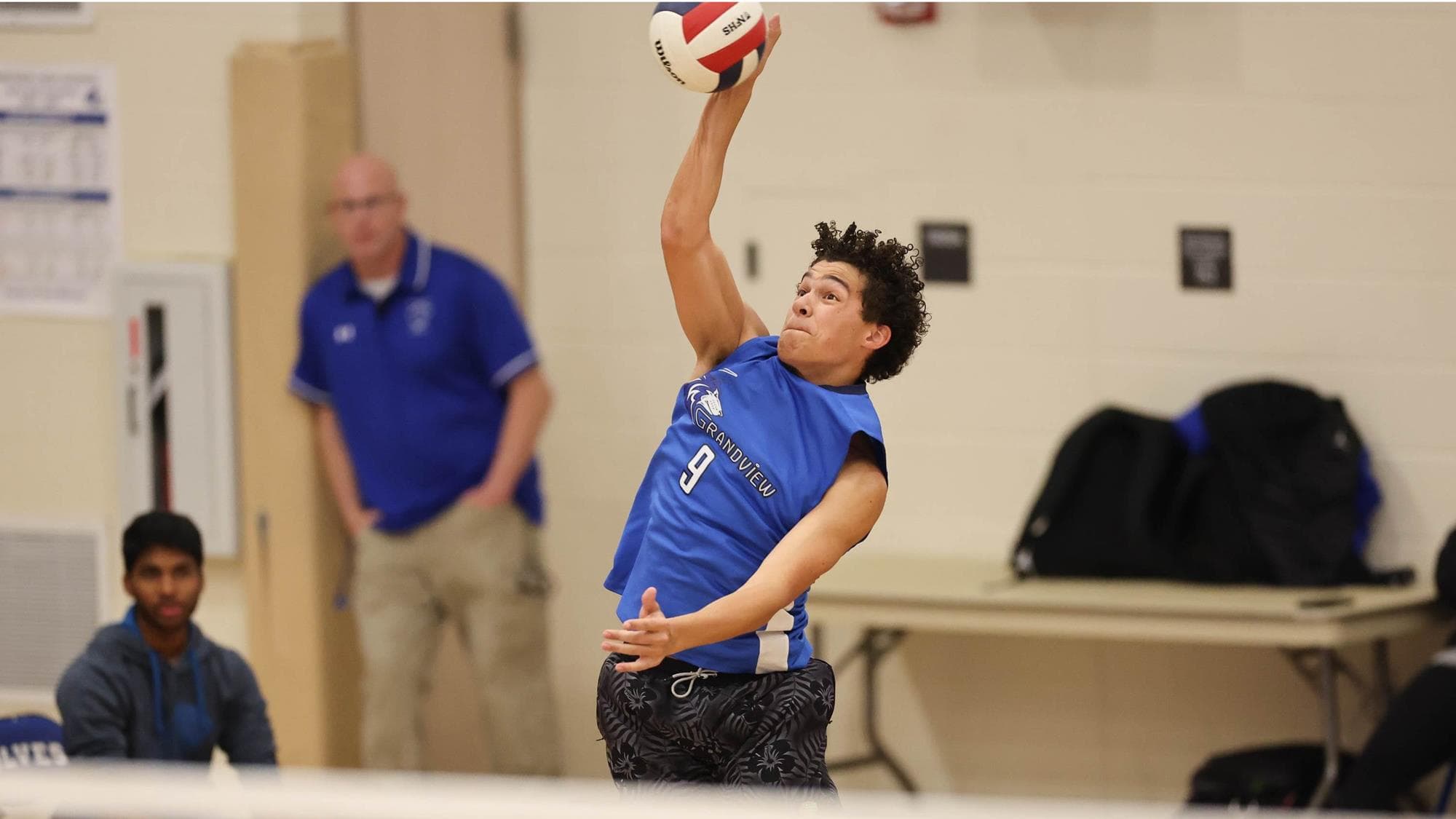 Devan Hall of Grandview serving in volleyball