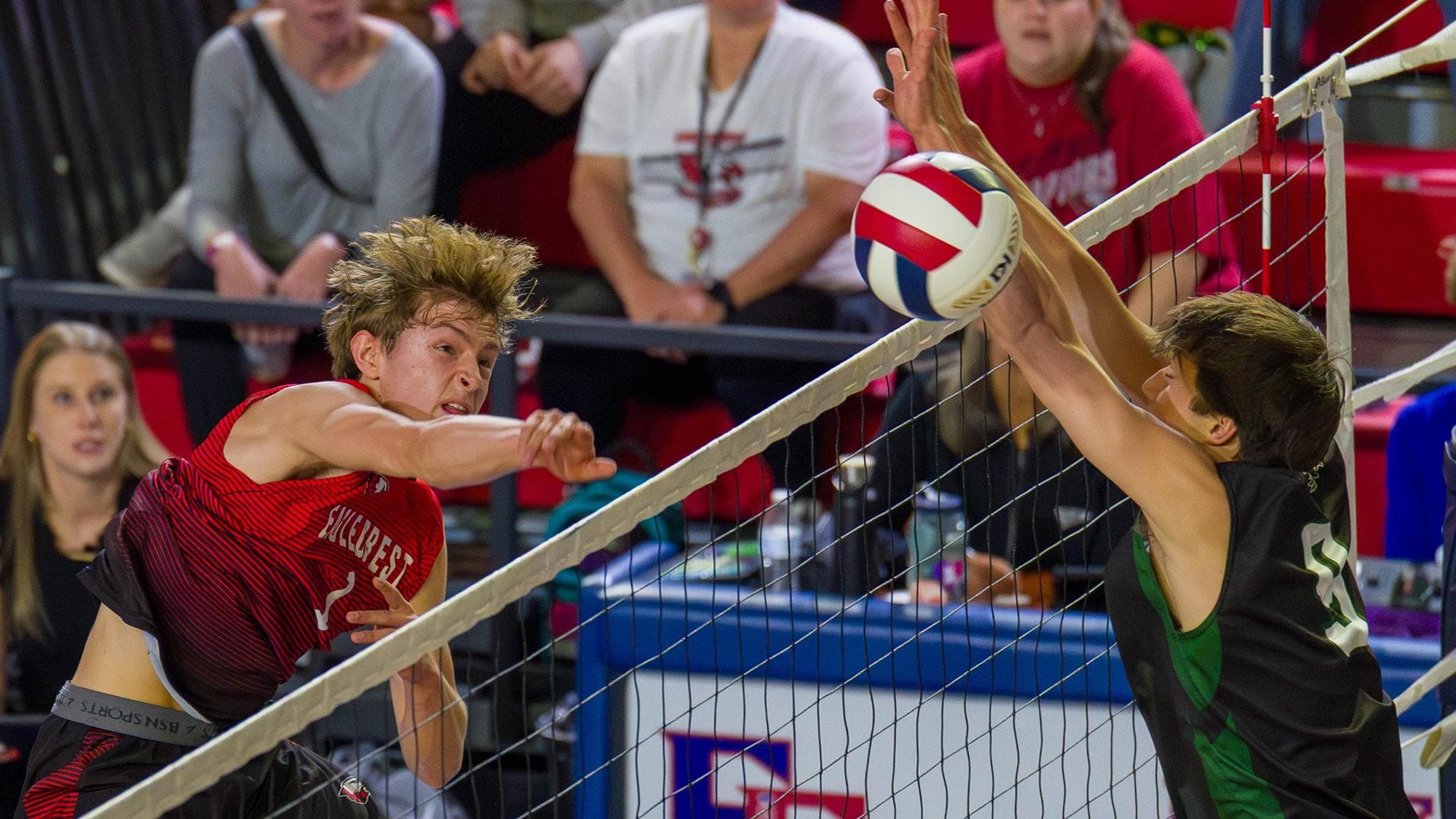 Eaglecrest's Will George follows through on an attack in volleyball