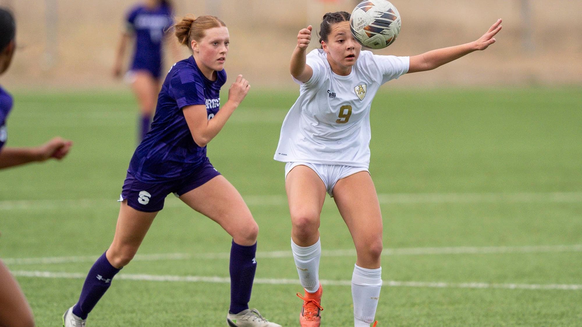 Jefferson Academy's Lily Glasmann about to head a soccer ball