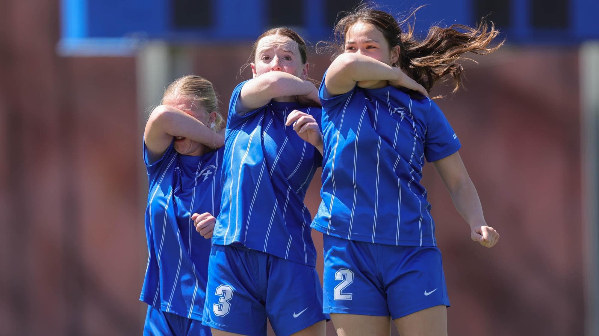 Denver Christian girls soccer jump while protecting their faces while defending against a free kick