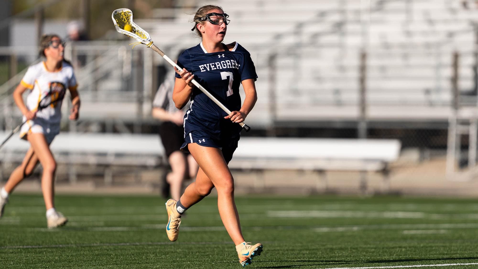 Addison White of Evergreen playing lacrosse