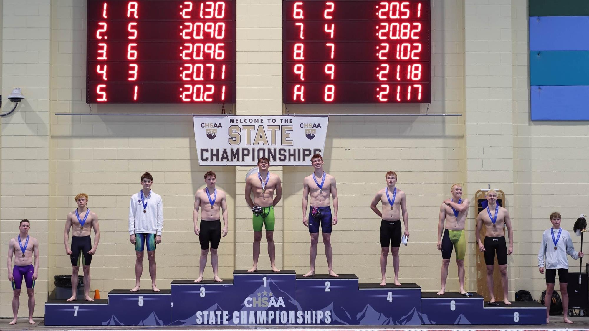 Medalists on the awards podium at the 2026 5A boys swimming & diving championships