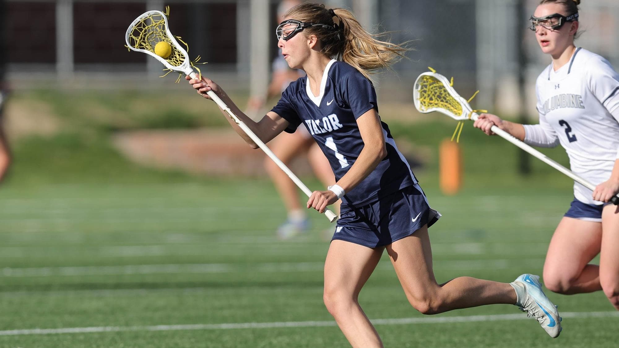 Gia Bigelow of Valor Christian, running while playing lacrosse