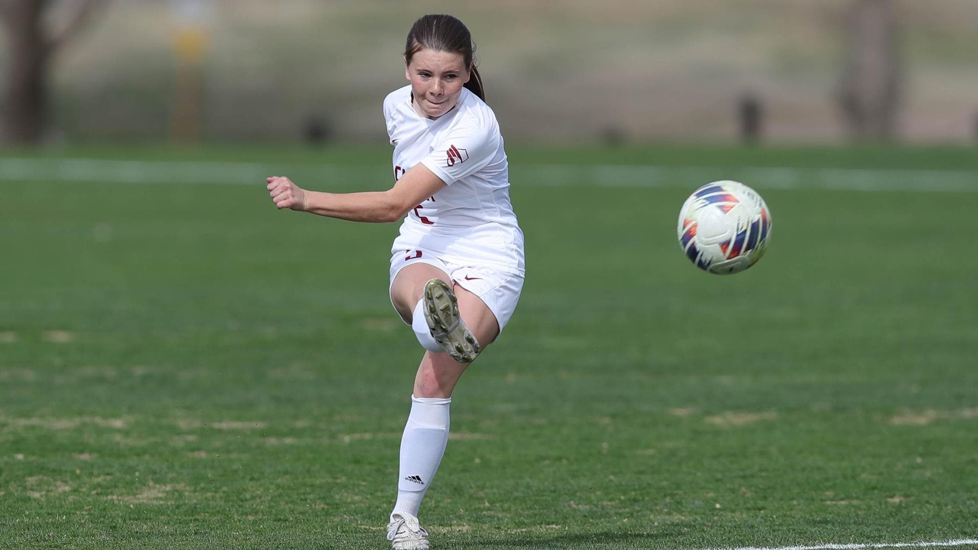 Emily Gilbert of Forge Christian following through after kicking the soccer ball