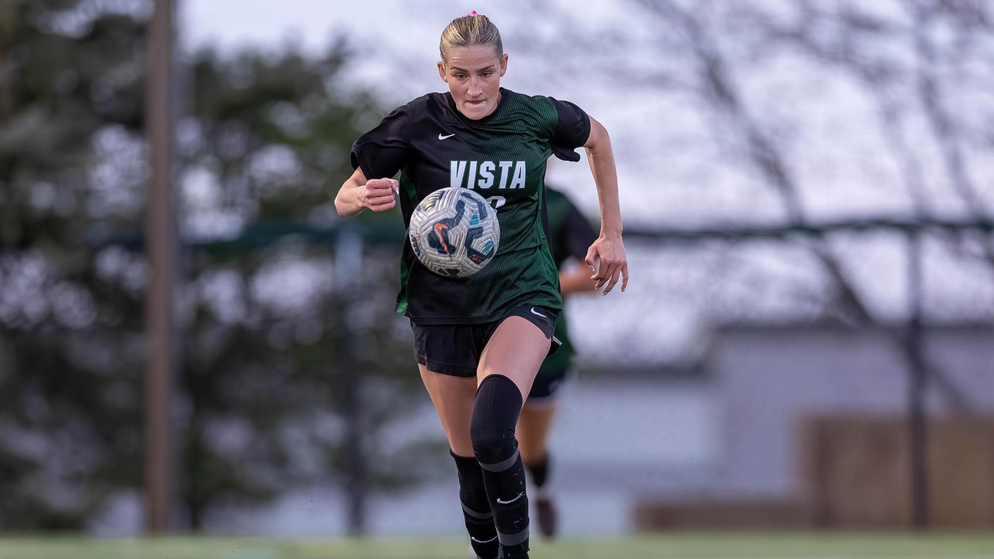 Avery Beer of Mountain Vista chases the soccer ball