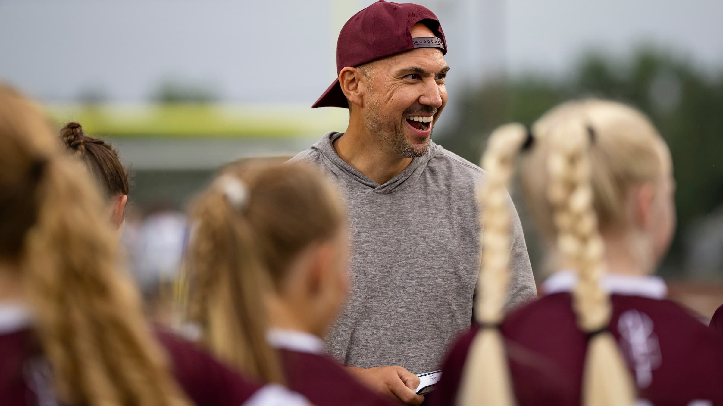 Jon Warga of Golden smiles while talking to his flag football team.