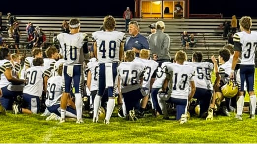 Tyler Vincent of Olathe talks to his football team