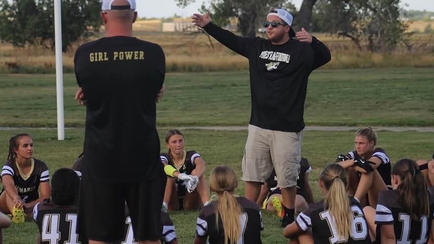 Colin Hart of Monarch talks to his flag football team